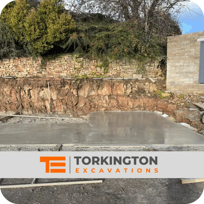 Excavator grading and levelling land for site preparation